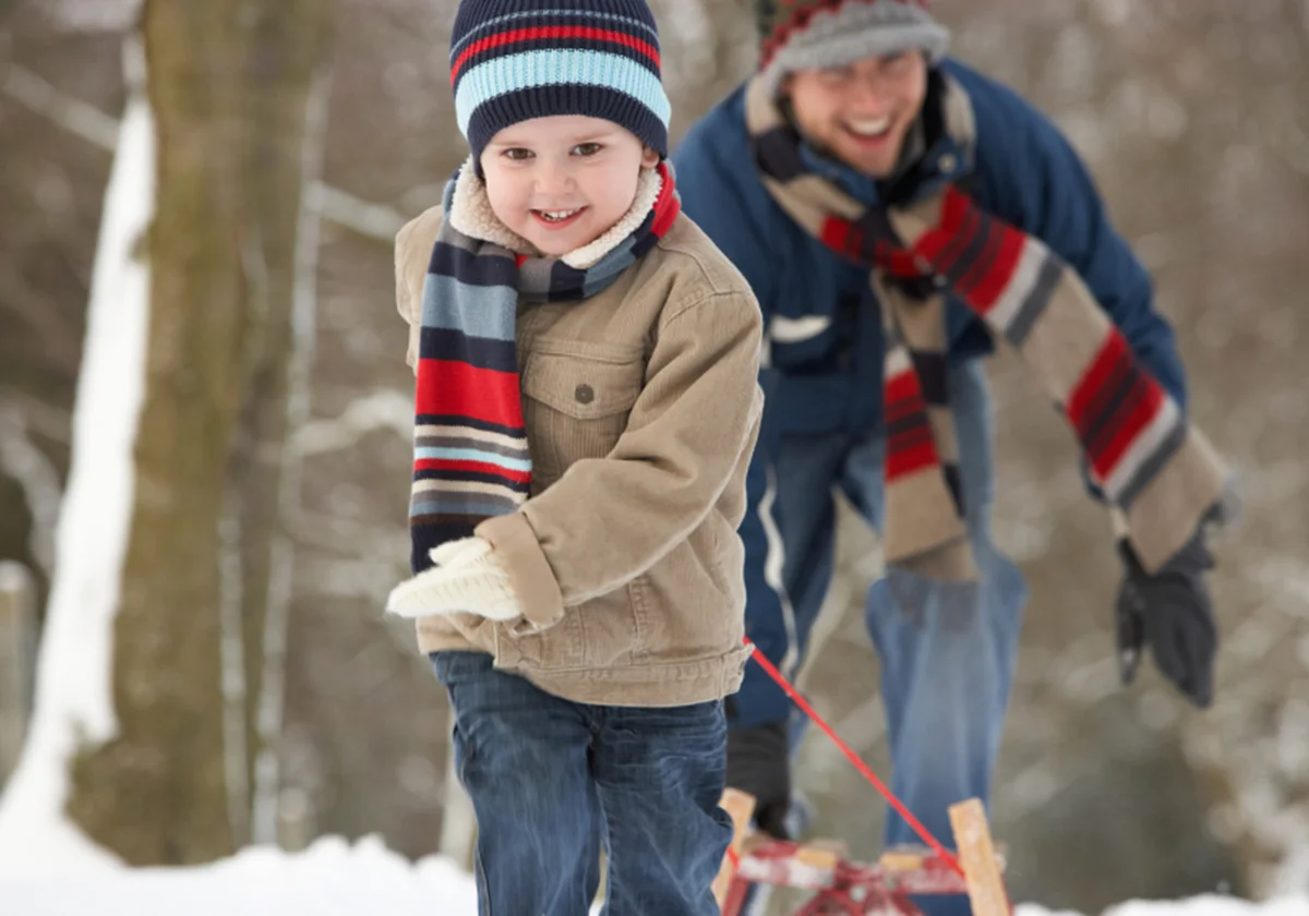 Dad and daughter walking in the snow