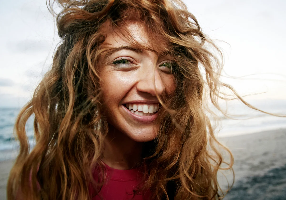 Wind blowing hair of woman on beach