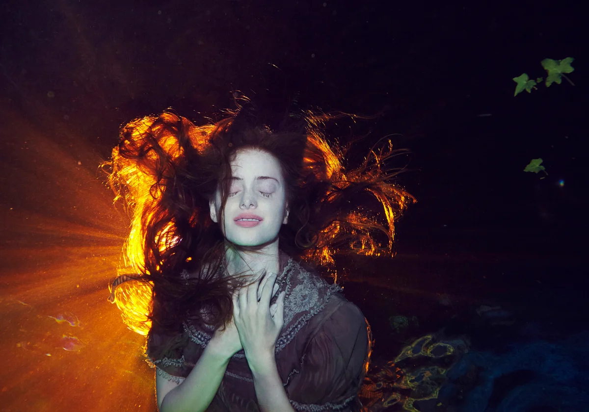 Woman Underwater holding heart