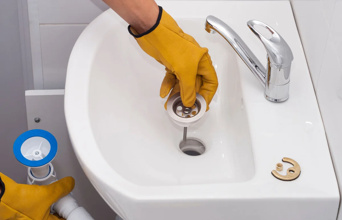 plumber installs a new siphon