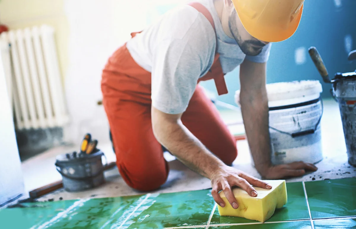 Handyman installing ceramic tiles