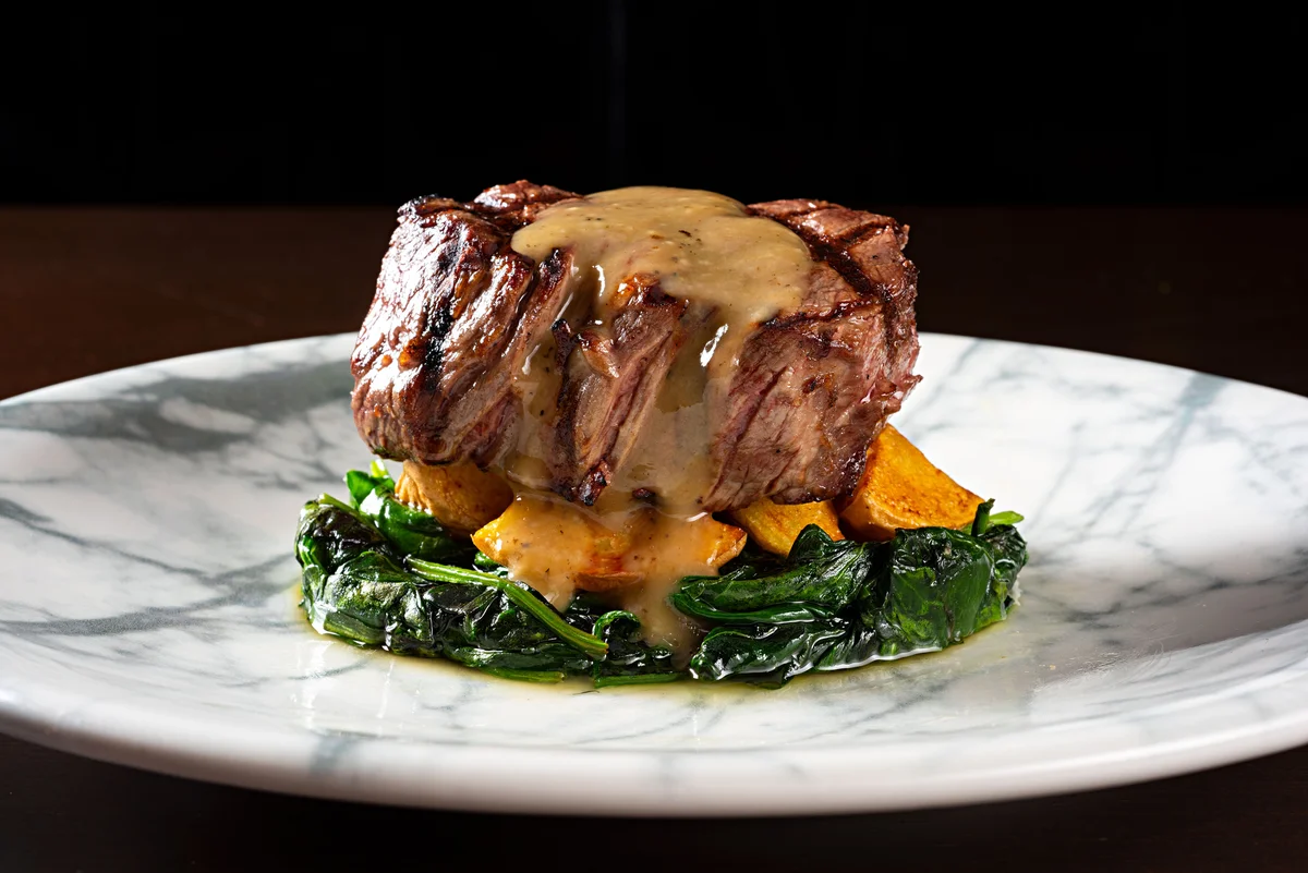 Steak on spinach with topping