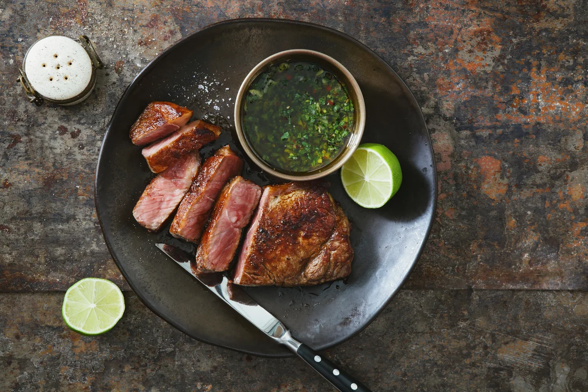 Steak with orange chimichurri sauce