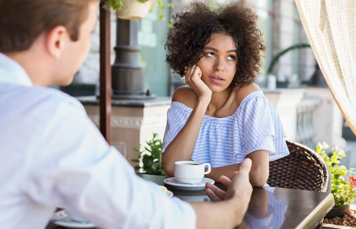woman disinterested with blind date outdoors