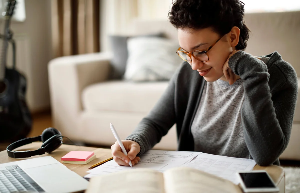 Smiling university student studying at home