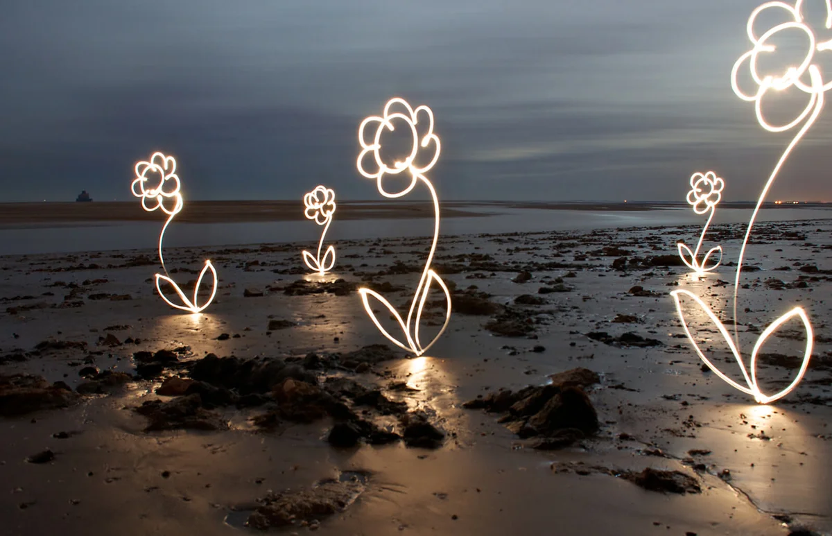 Light painting photography flowers on beach