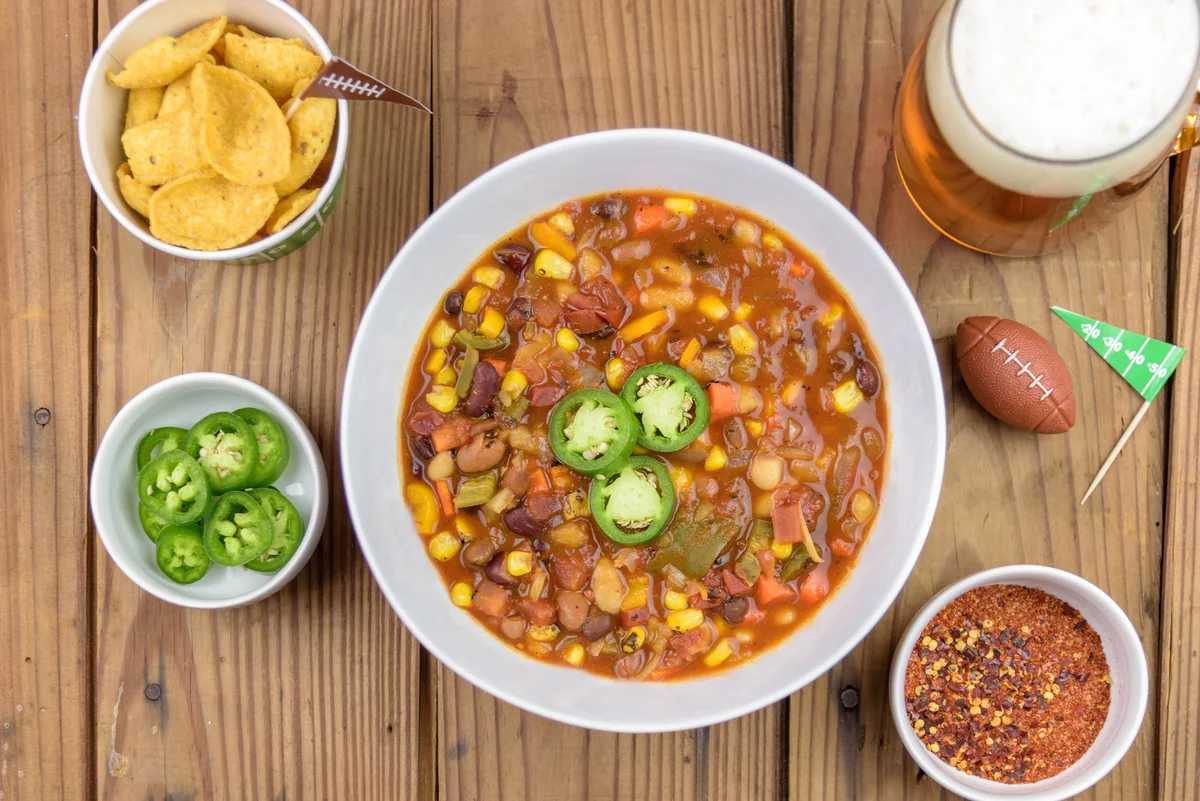 Vegetarian chili and mug of beer with football theme