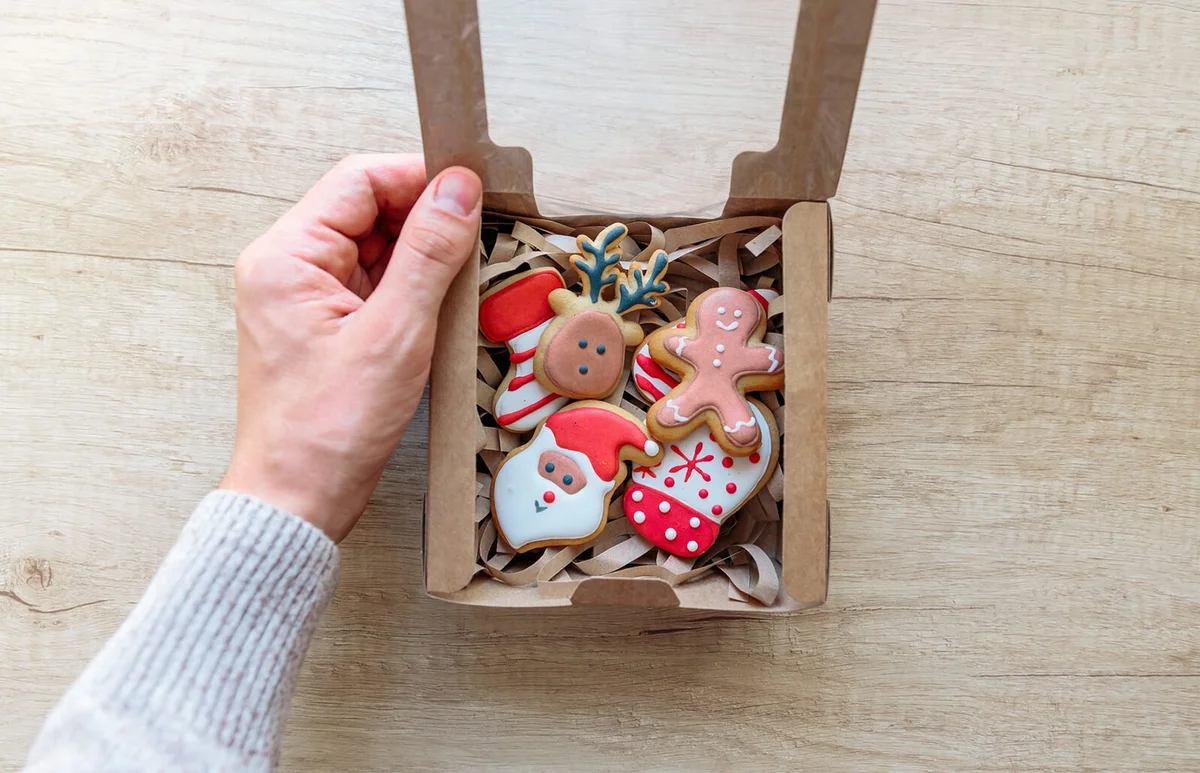 Opening Christmas present with Christmas cookies