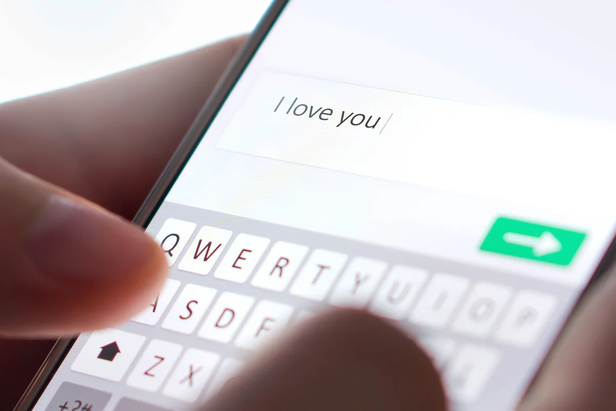 Sending I love you text message with mobile phone