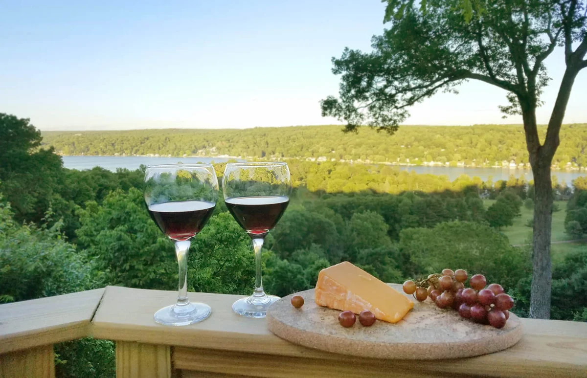 2 Filled Red Wine Glasses with Compliment of Cheese and Grapes in Finger Lakes