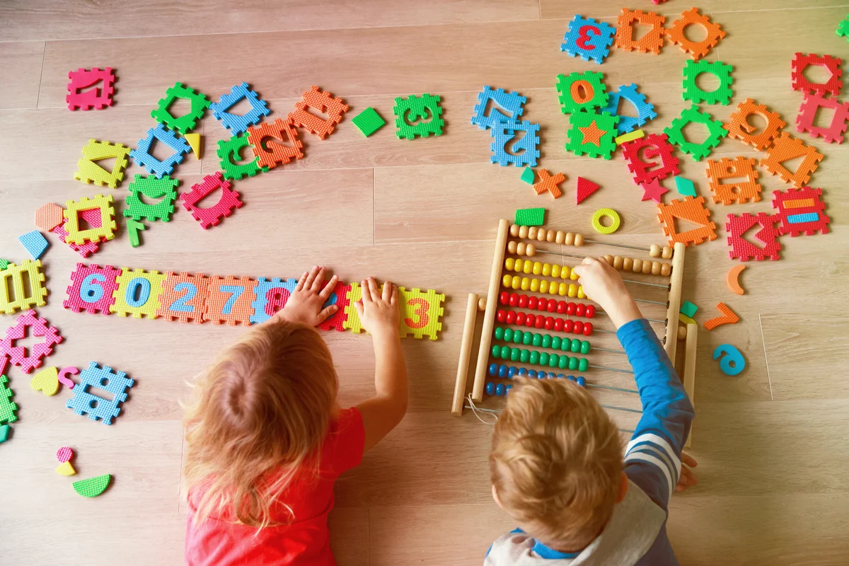 Little boy and girl learn to calculate numbers