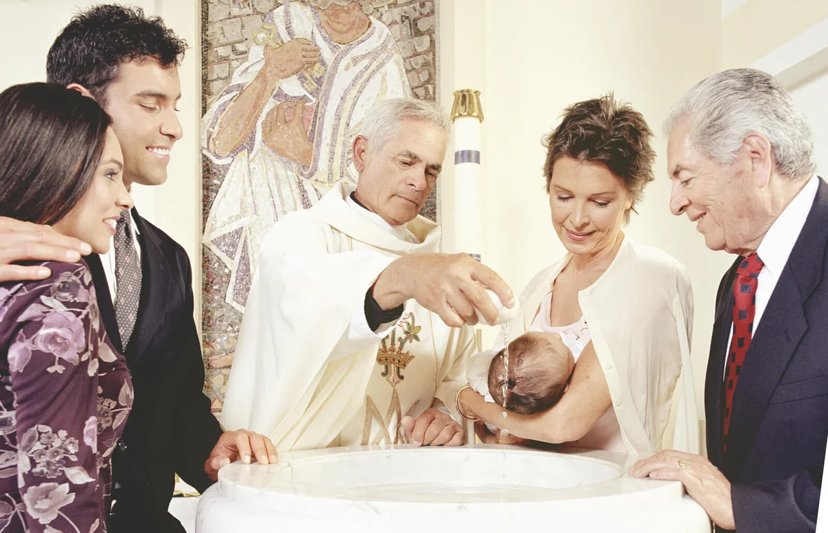 Baby boy (0-3 months) being baptised