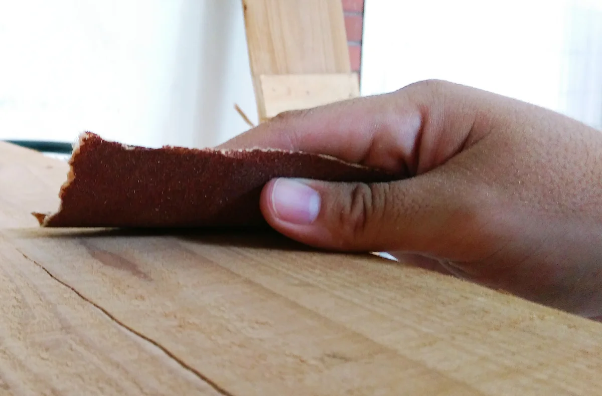 Man Using Sand Paper On Wood