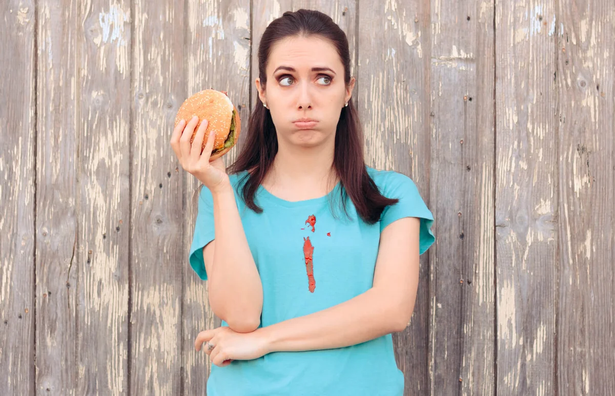 Clumsy Woman Staining Her Shirt with Ketchup Sauce