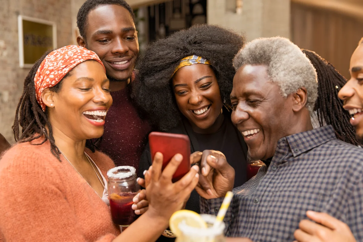 Happy multi-generation family using smart phone