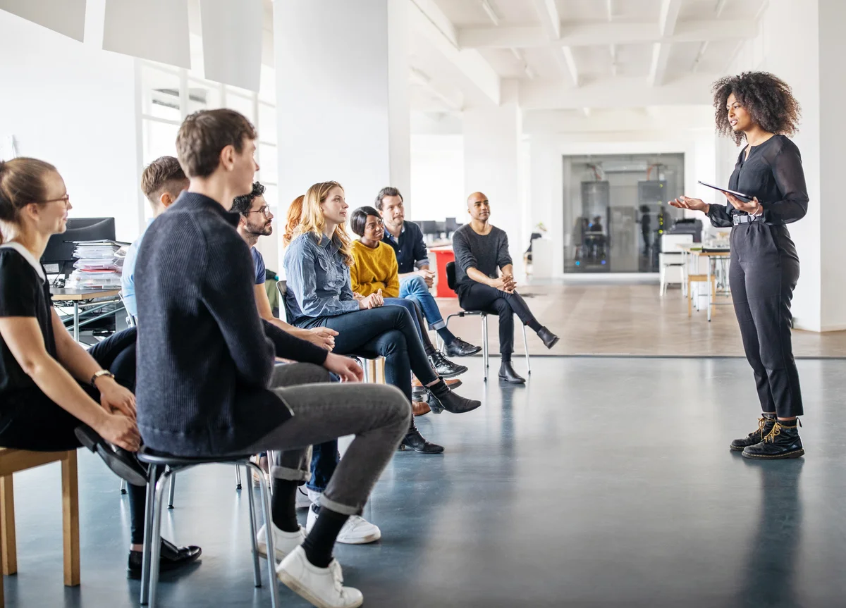 woman sharing her views with team in office meeting