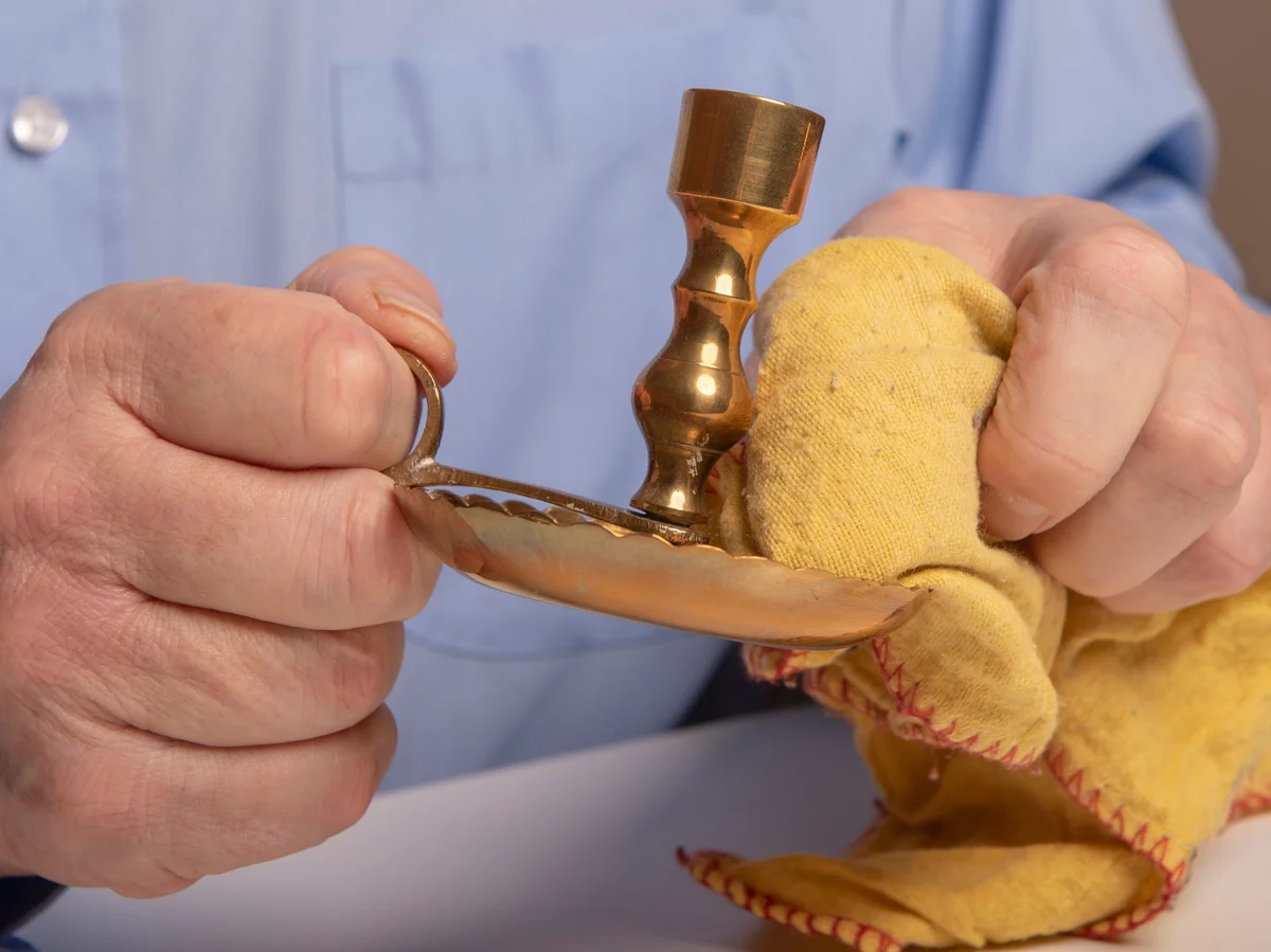 polishing brass candle sticks