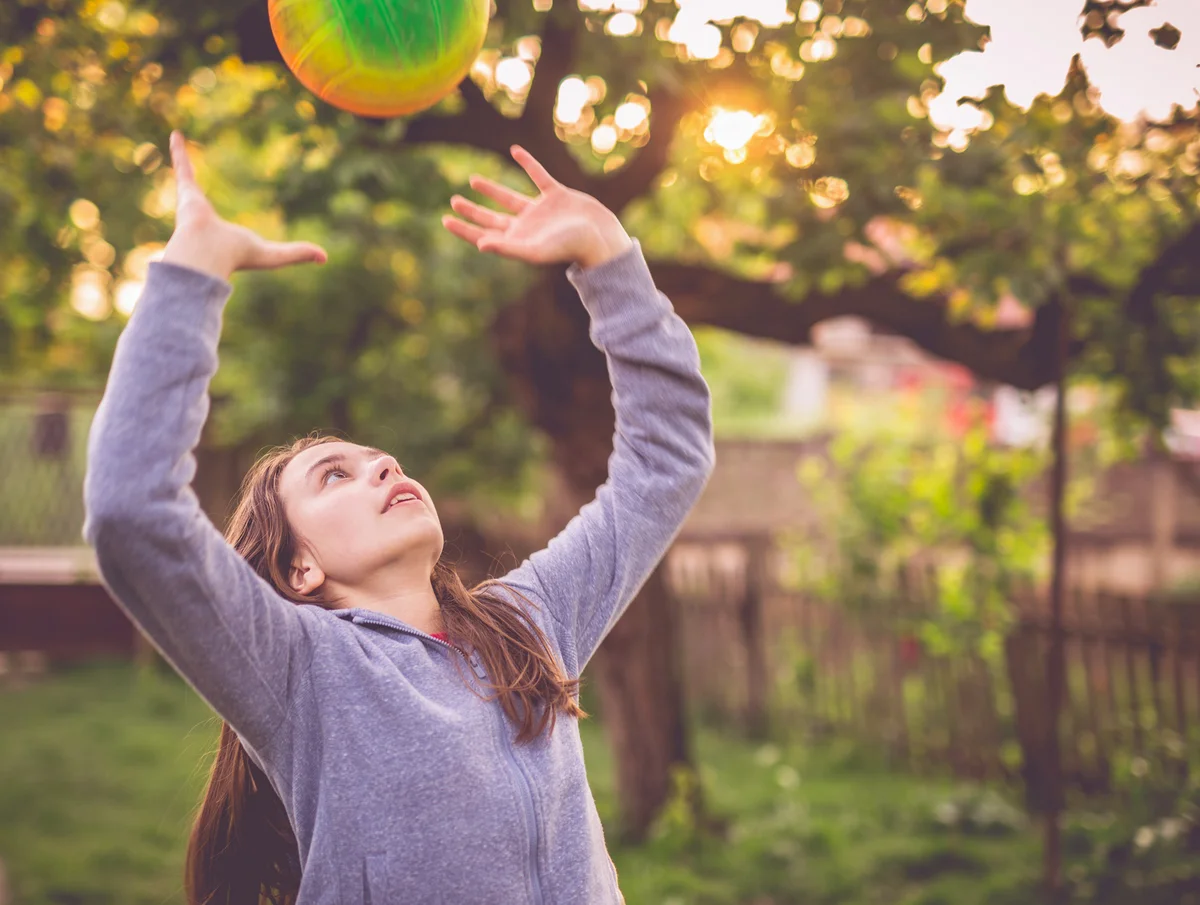 Girl playing volleyball setting up