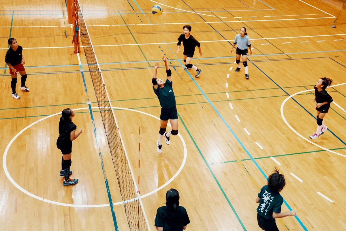 girls playing a volleyball game