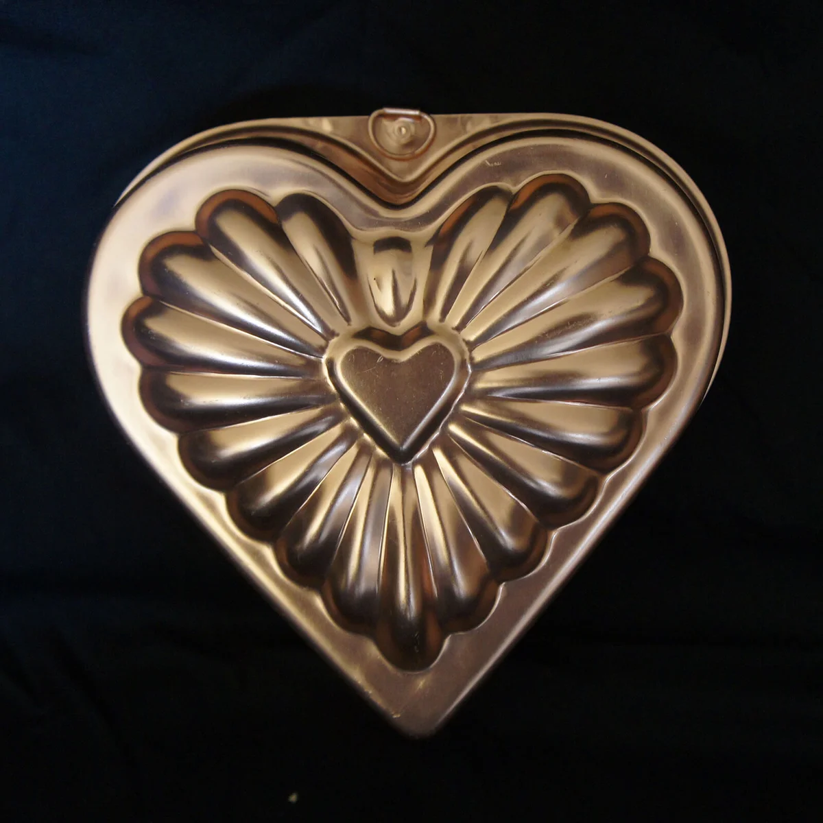 A copper heart shaped valentine jello mold