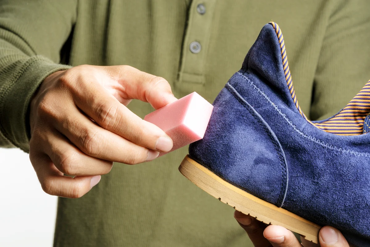 Man cleaning his suede shoe