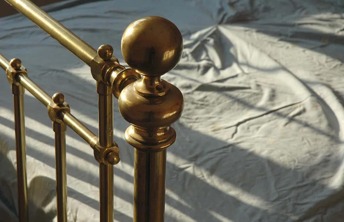 Antique brass bed rail, evening light