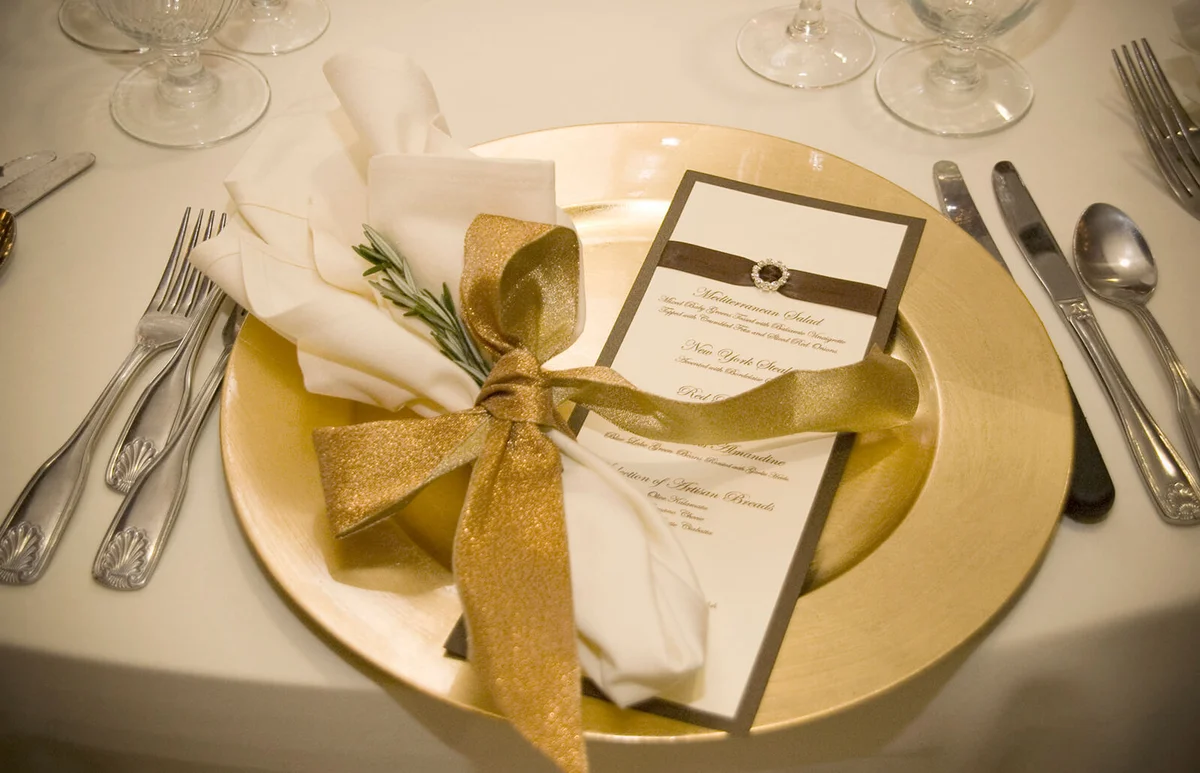 Gold and linen place settling with rosemary
