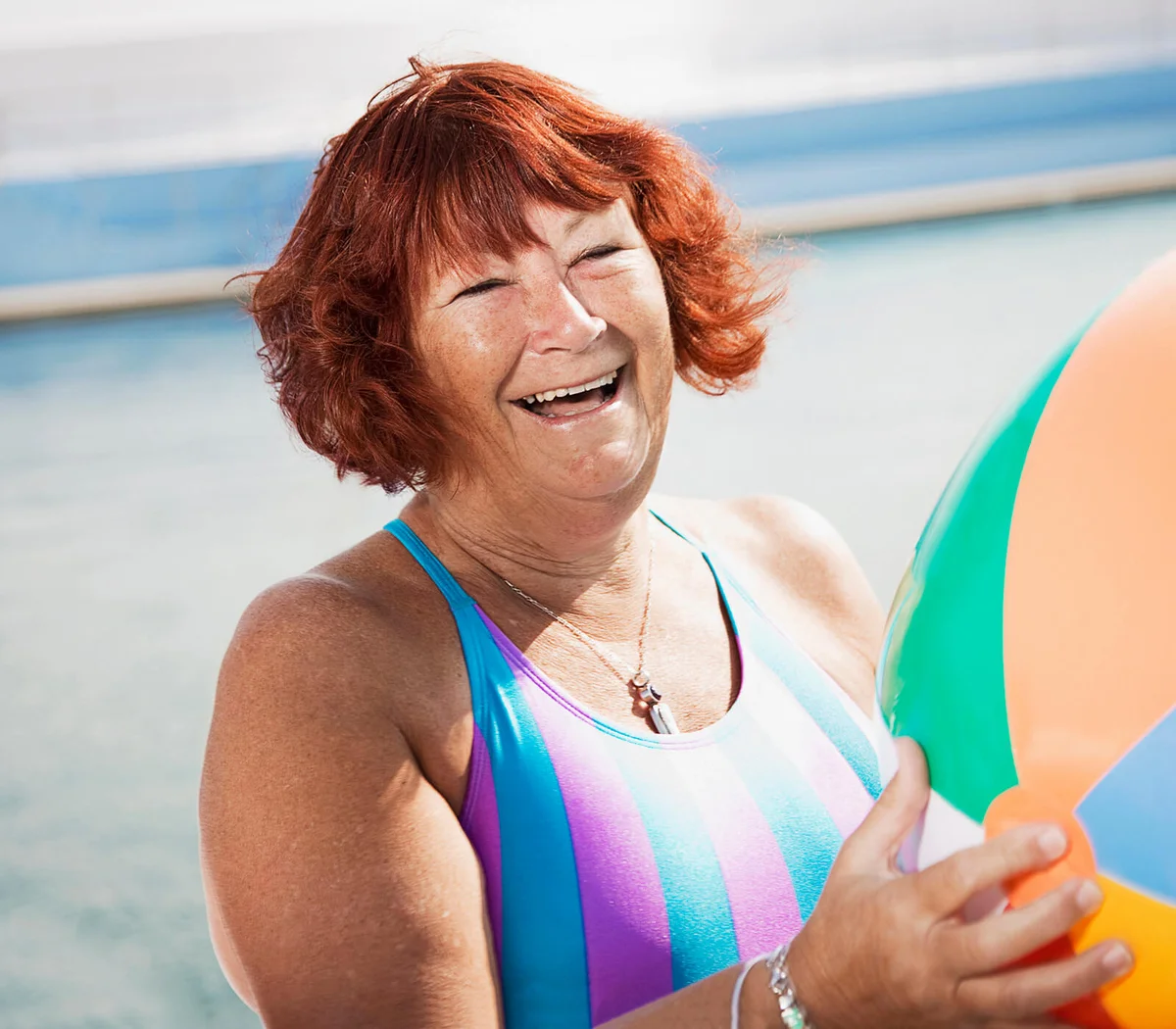 Woman laughing holding a beach ball