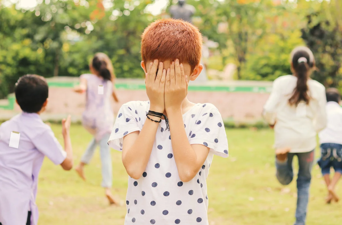 Children playing hide and seek freeze tag game outside