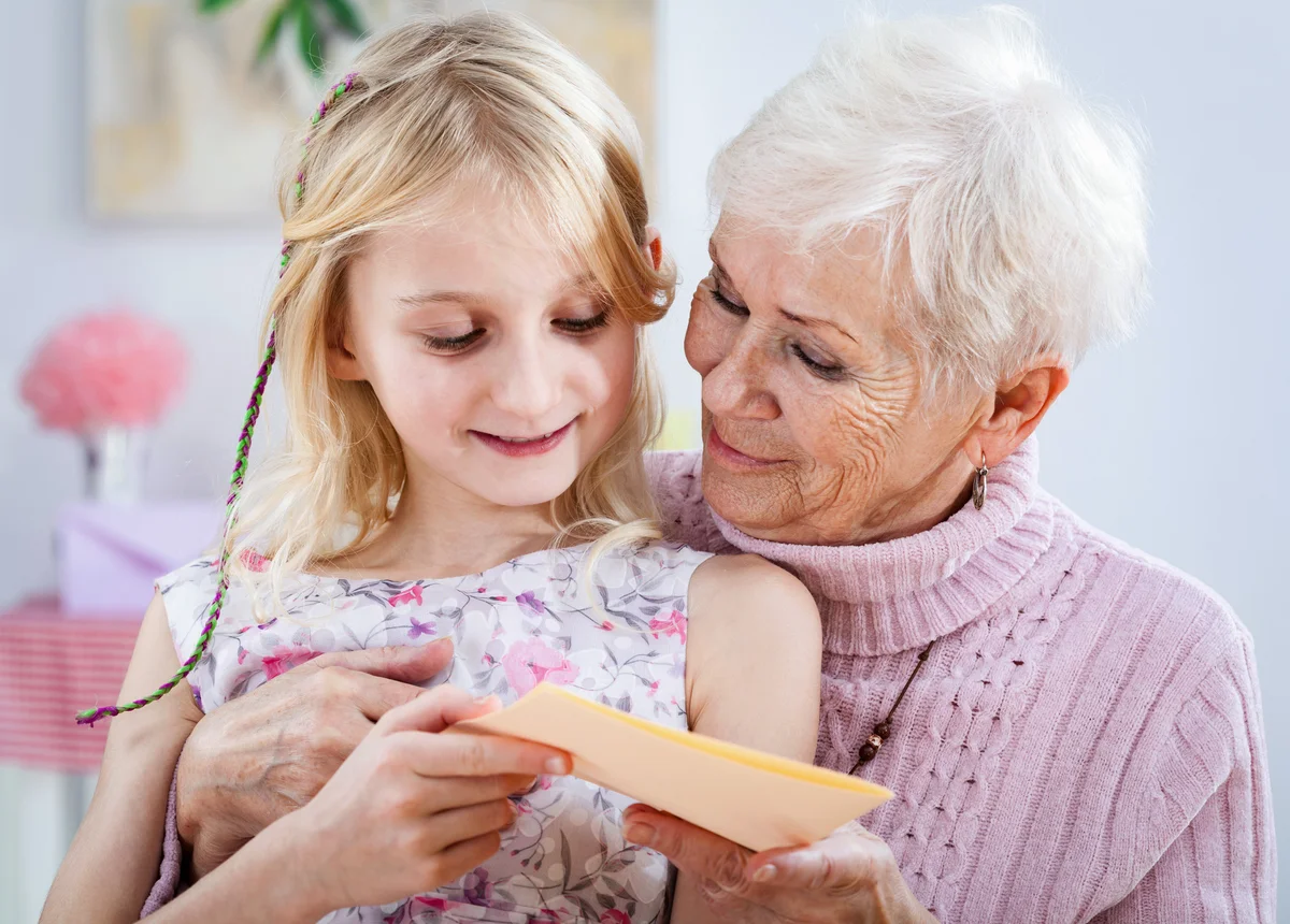 A grandma with a birthday card from her granddaughter