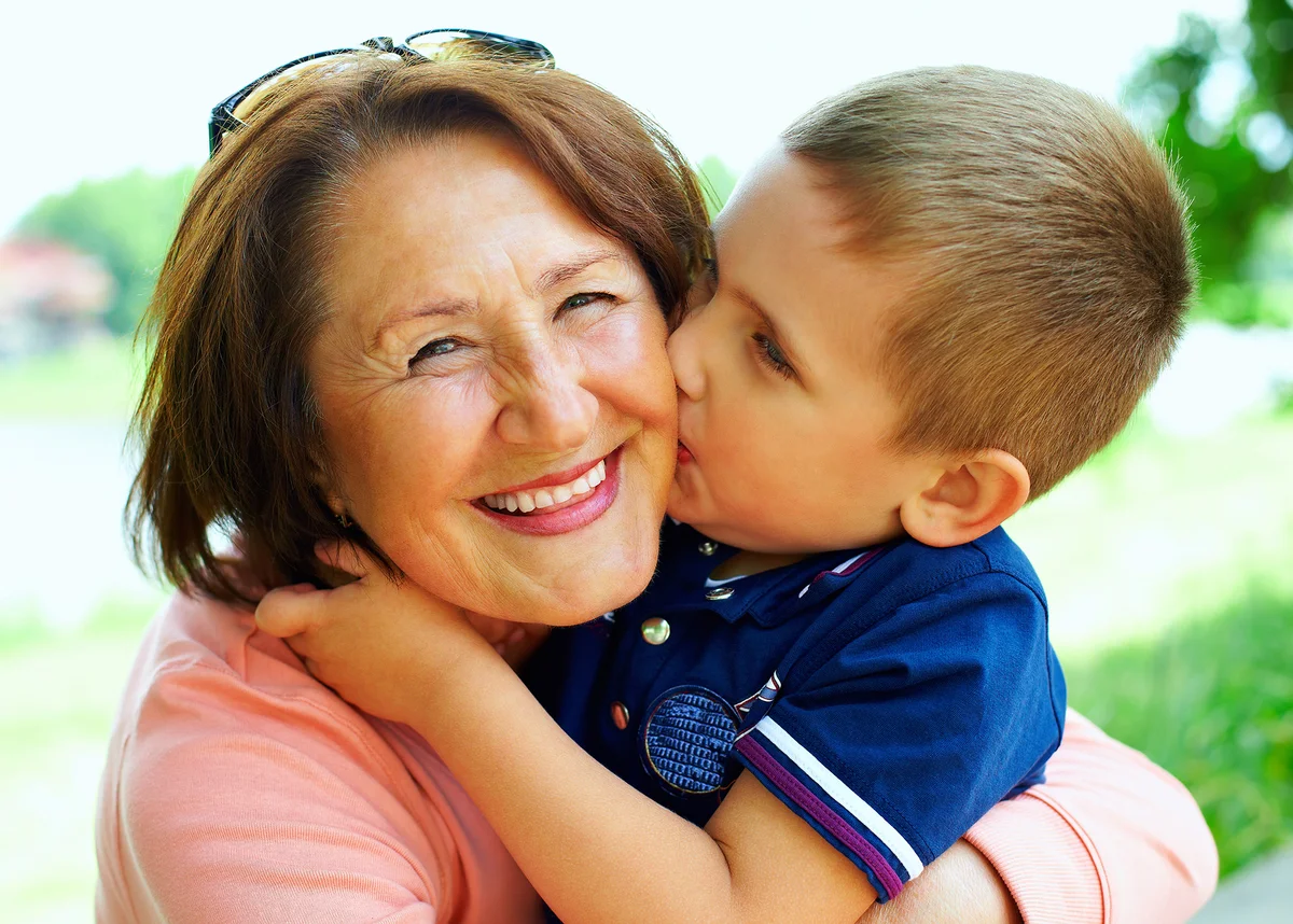 happy grandma with grandson embracing