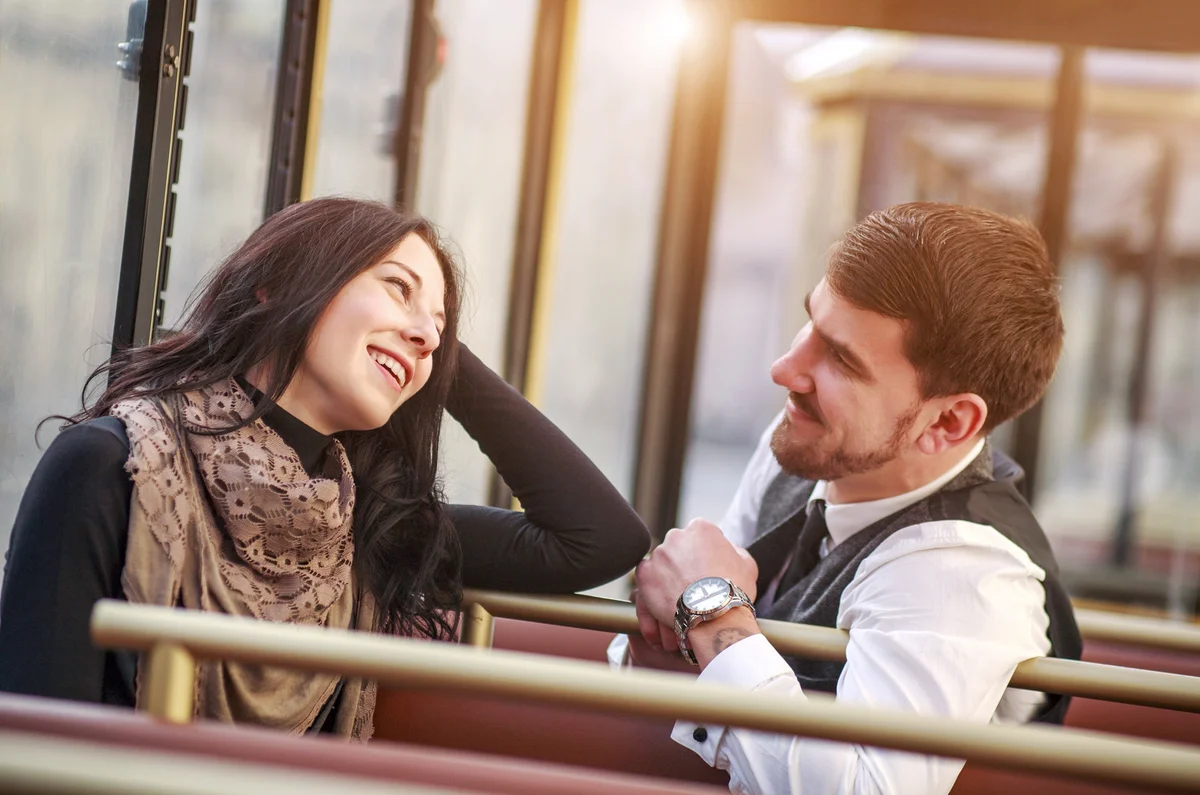 Young guy meets and talks to girl in tram