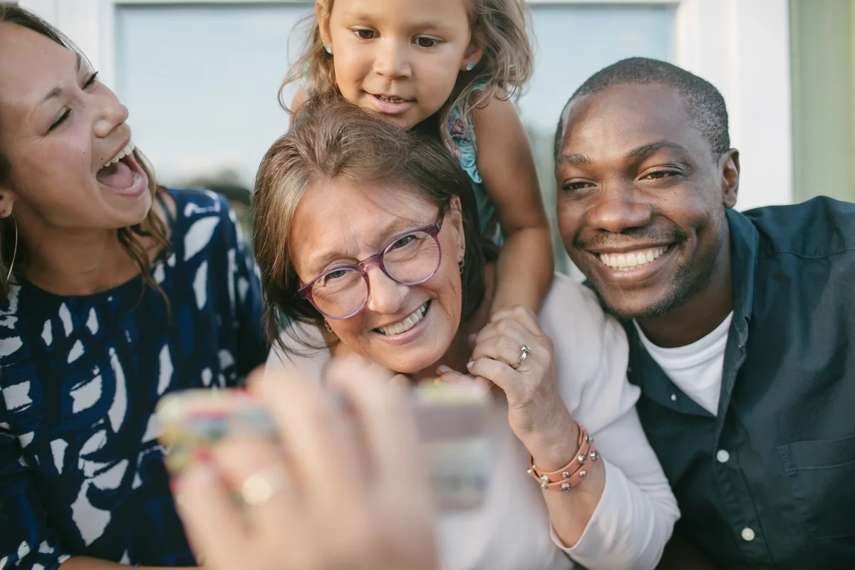 happy multi-cultural family on porch