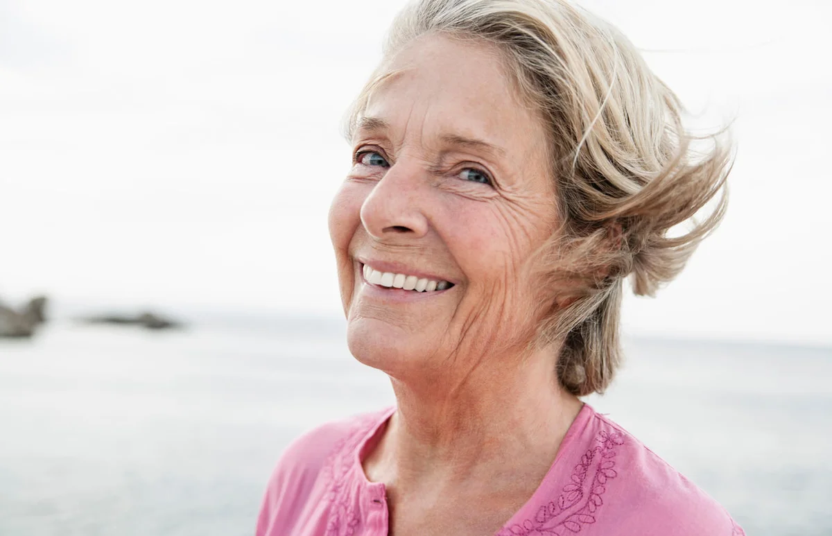 Senior woman smiling at Atlantic ocean