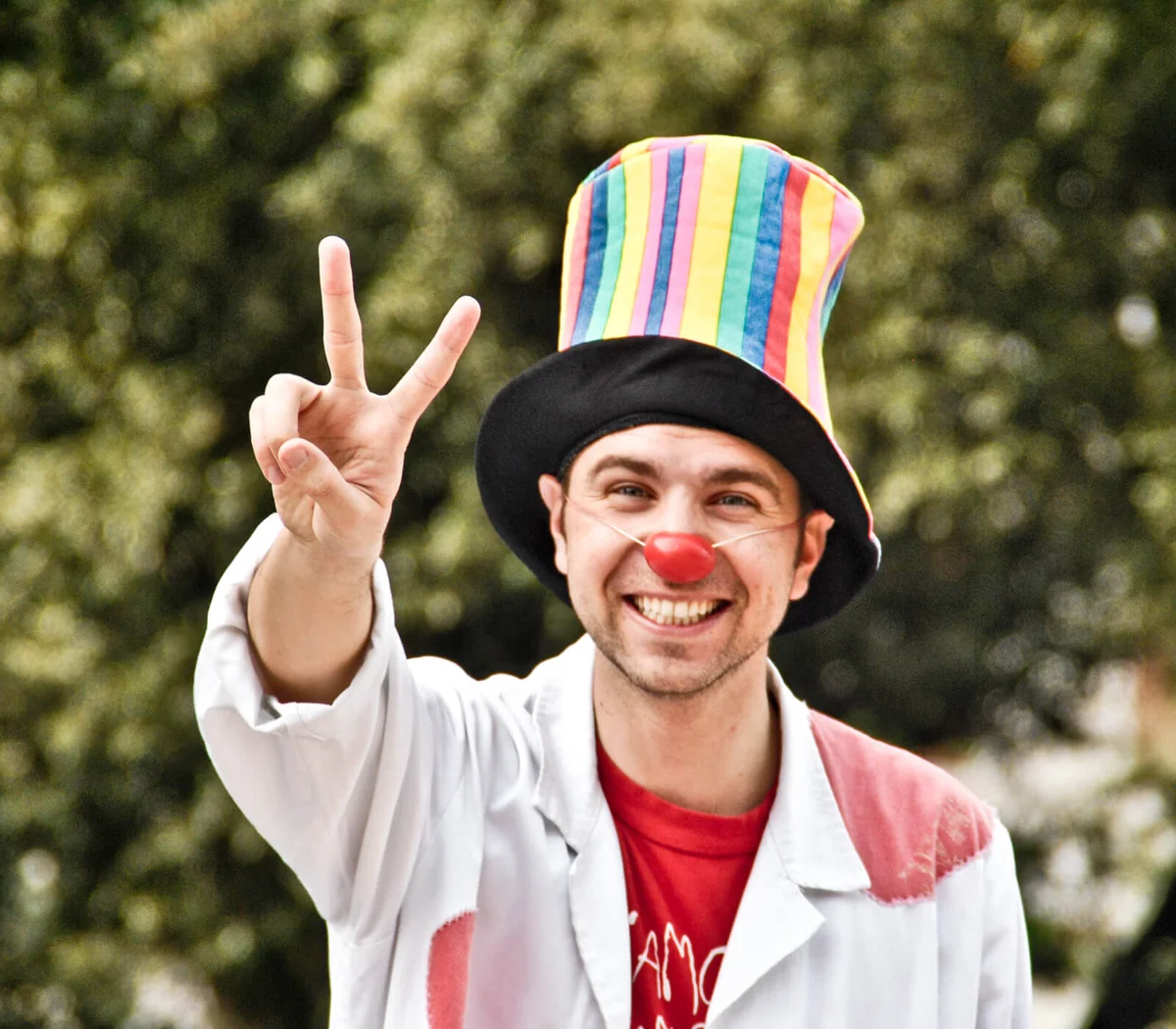 Clown with red nose and hat smiling