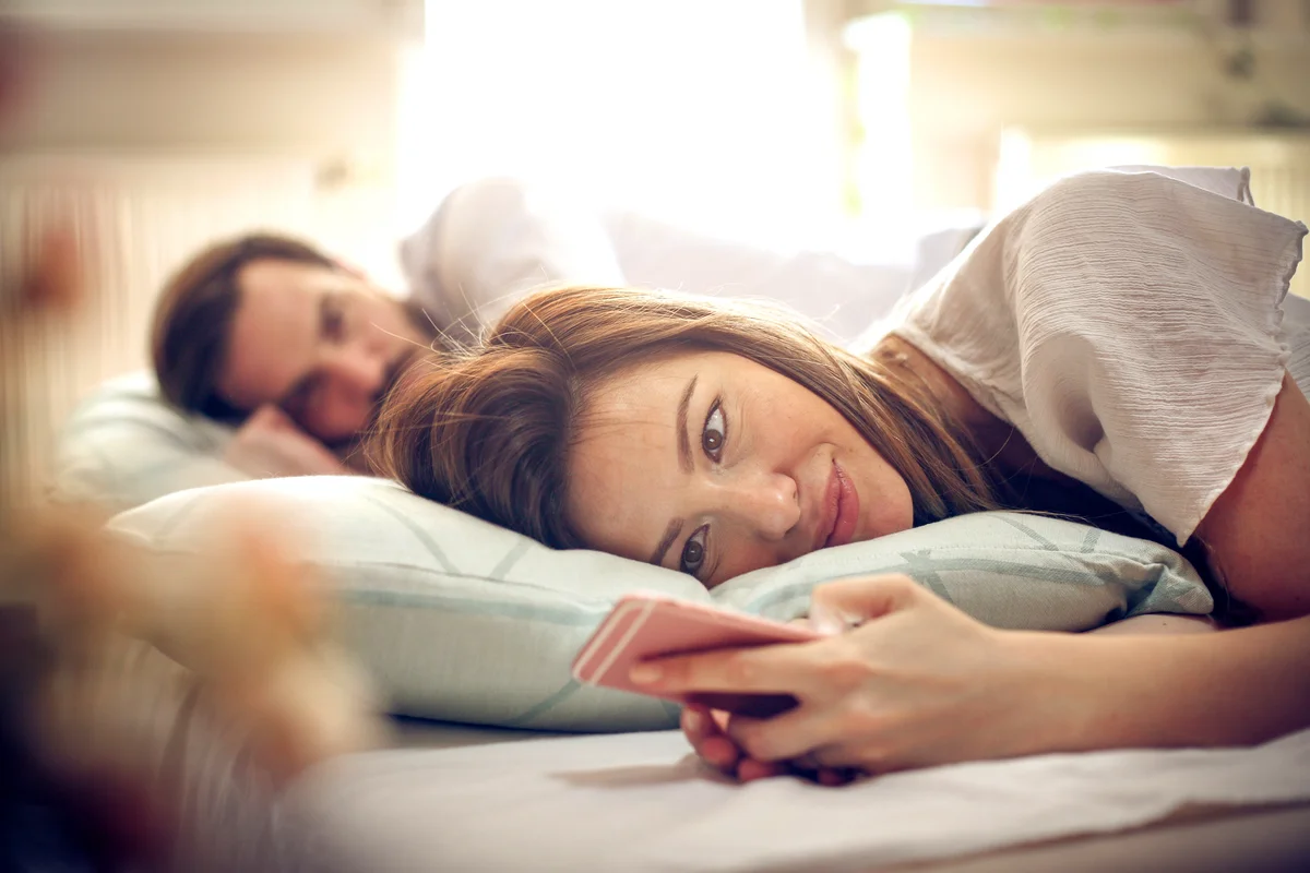 Young couple in bed. Focus on woman