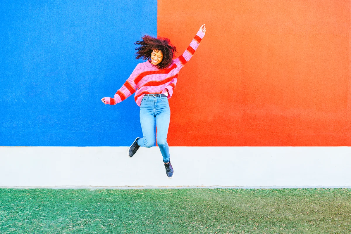 Happy young woman jumping in the air