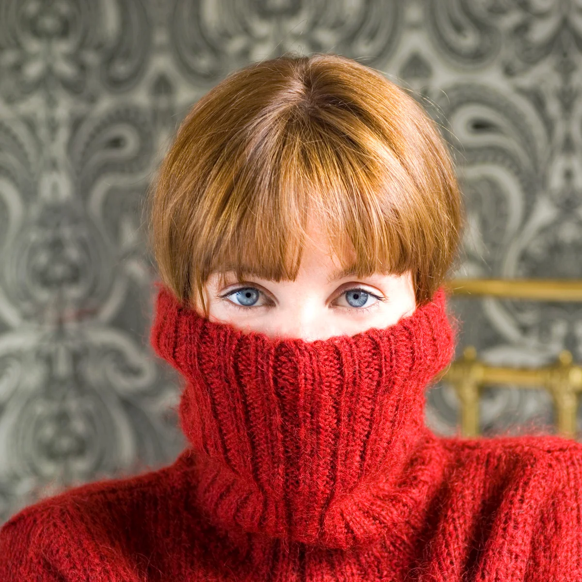 Woman with jumper pulled over face
