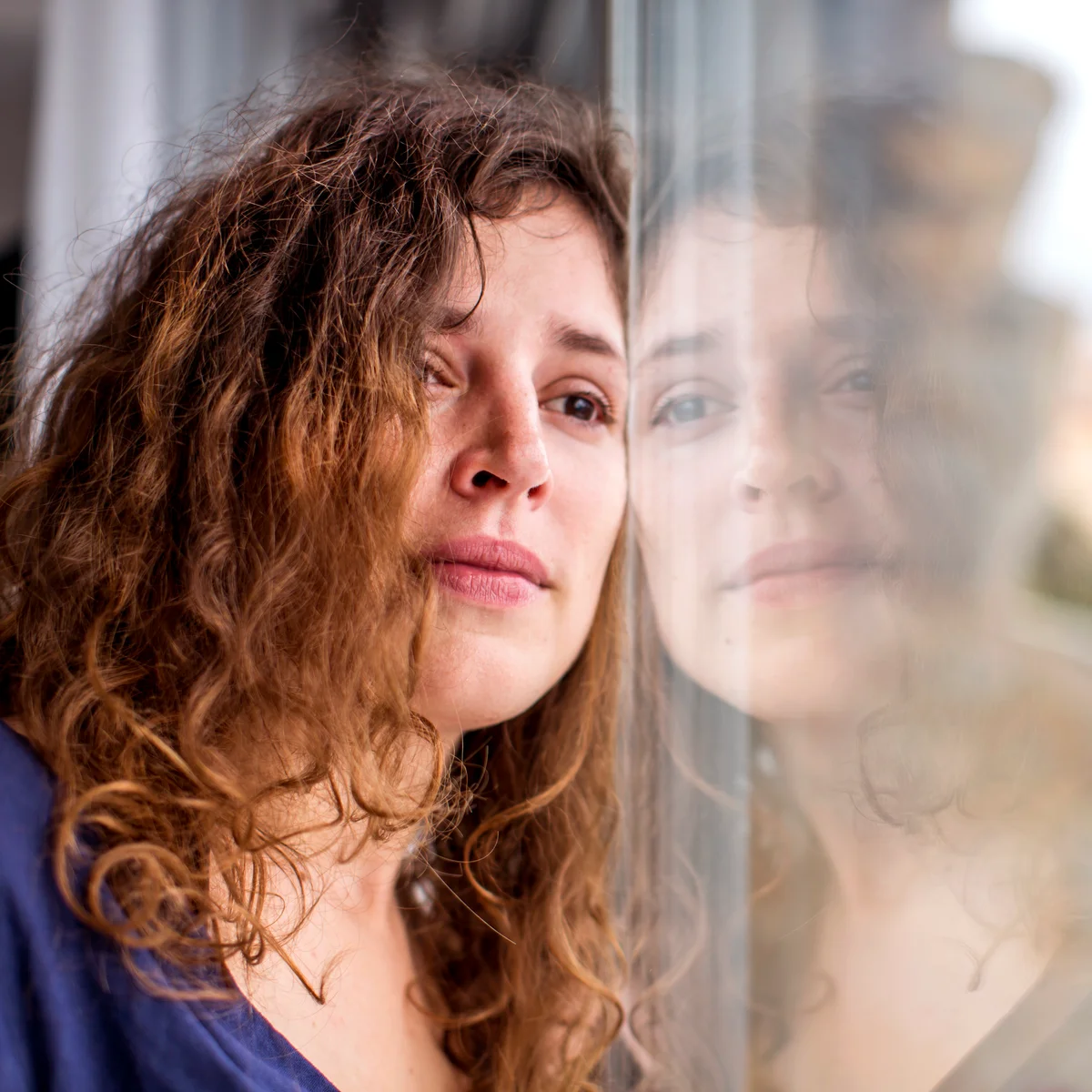 Sad woman looking out of the window