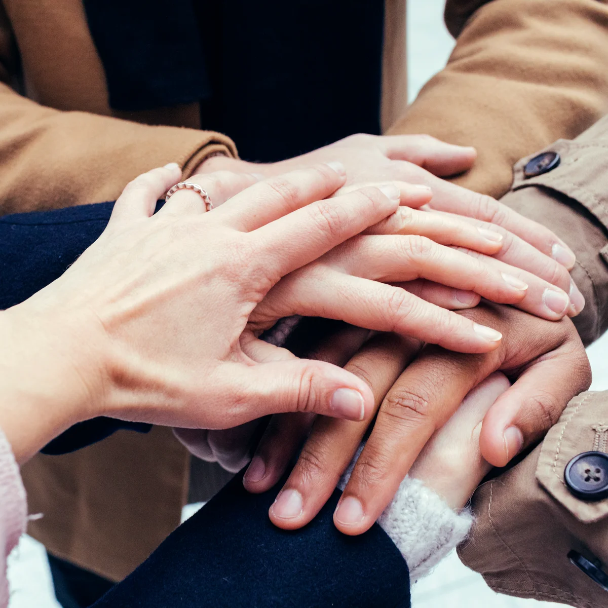 Group of friends putting hands together