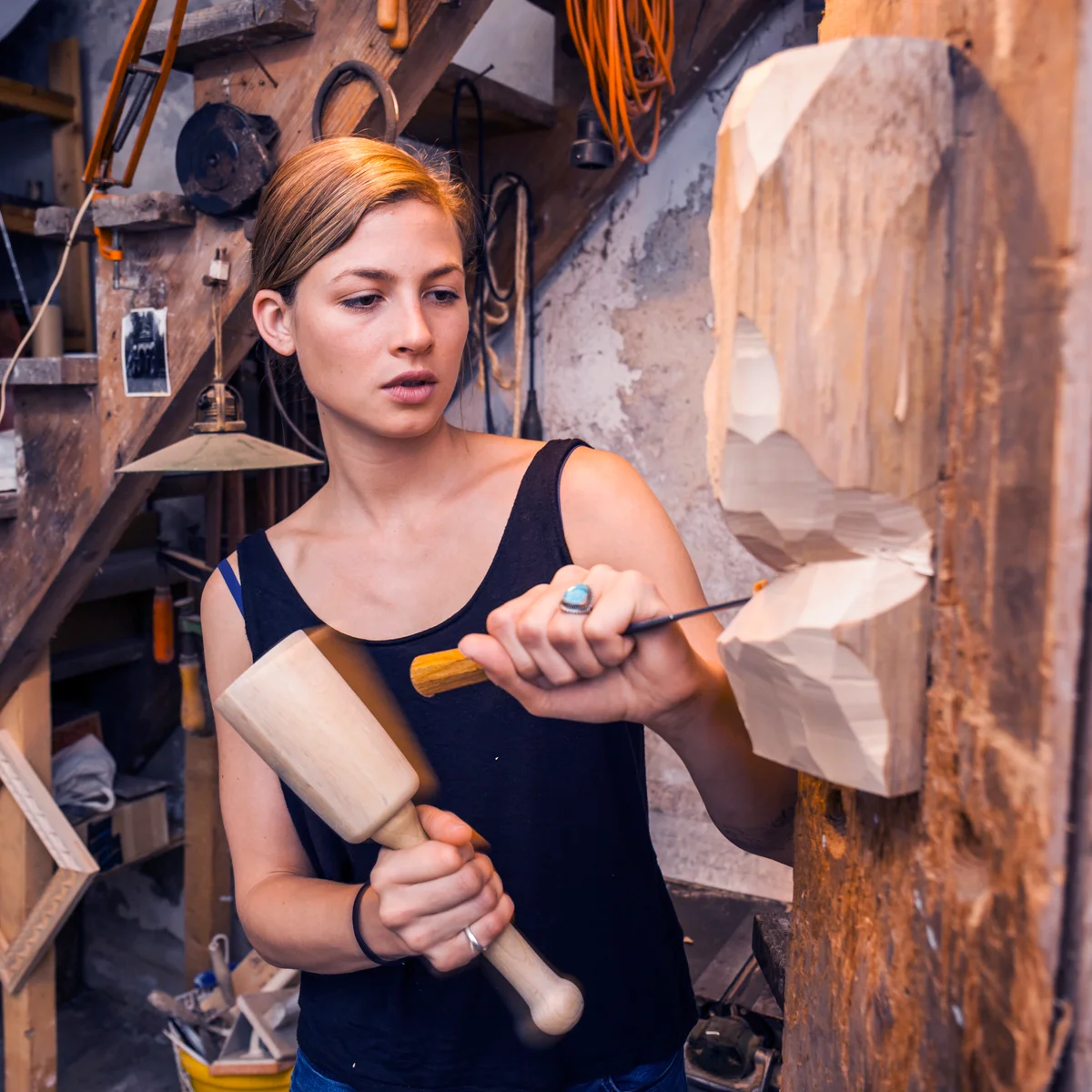 Sculptress carving wooden figure