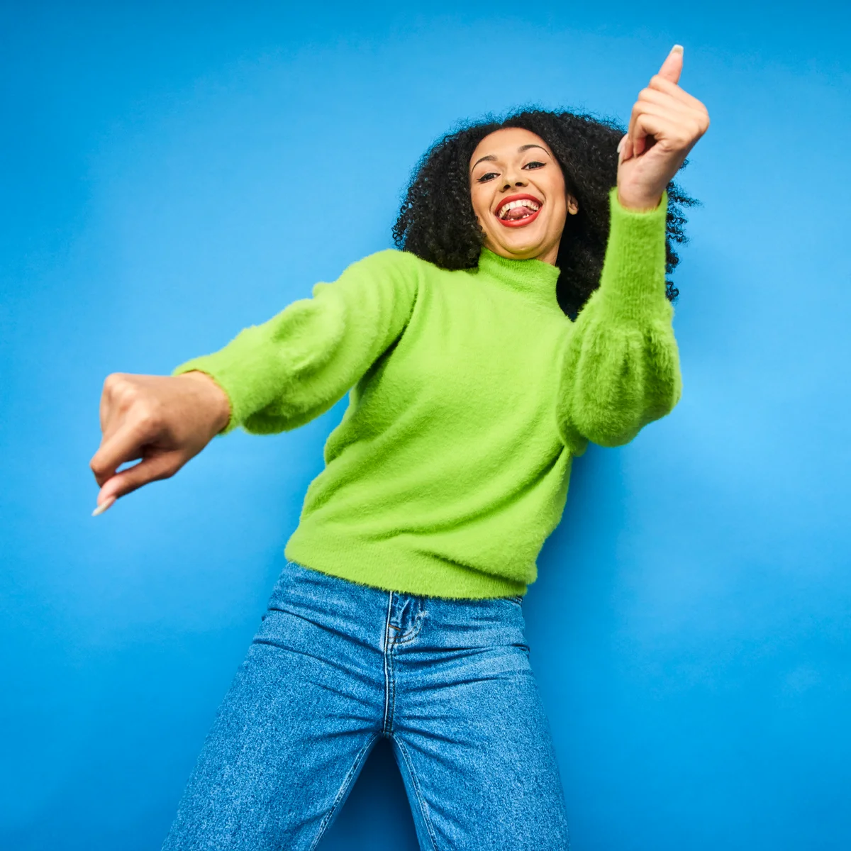 Colourful studio portrait of a young woman dancing