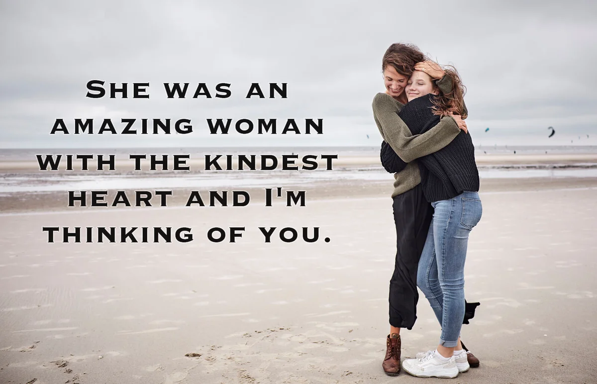 Happy young woman hugging girl on the beach