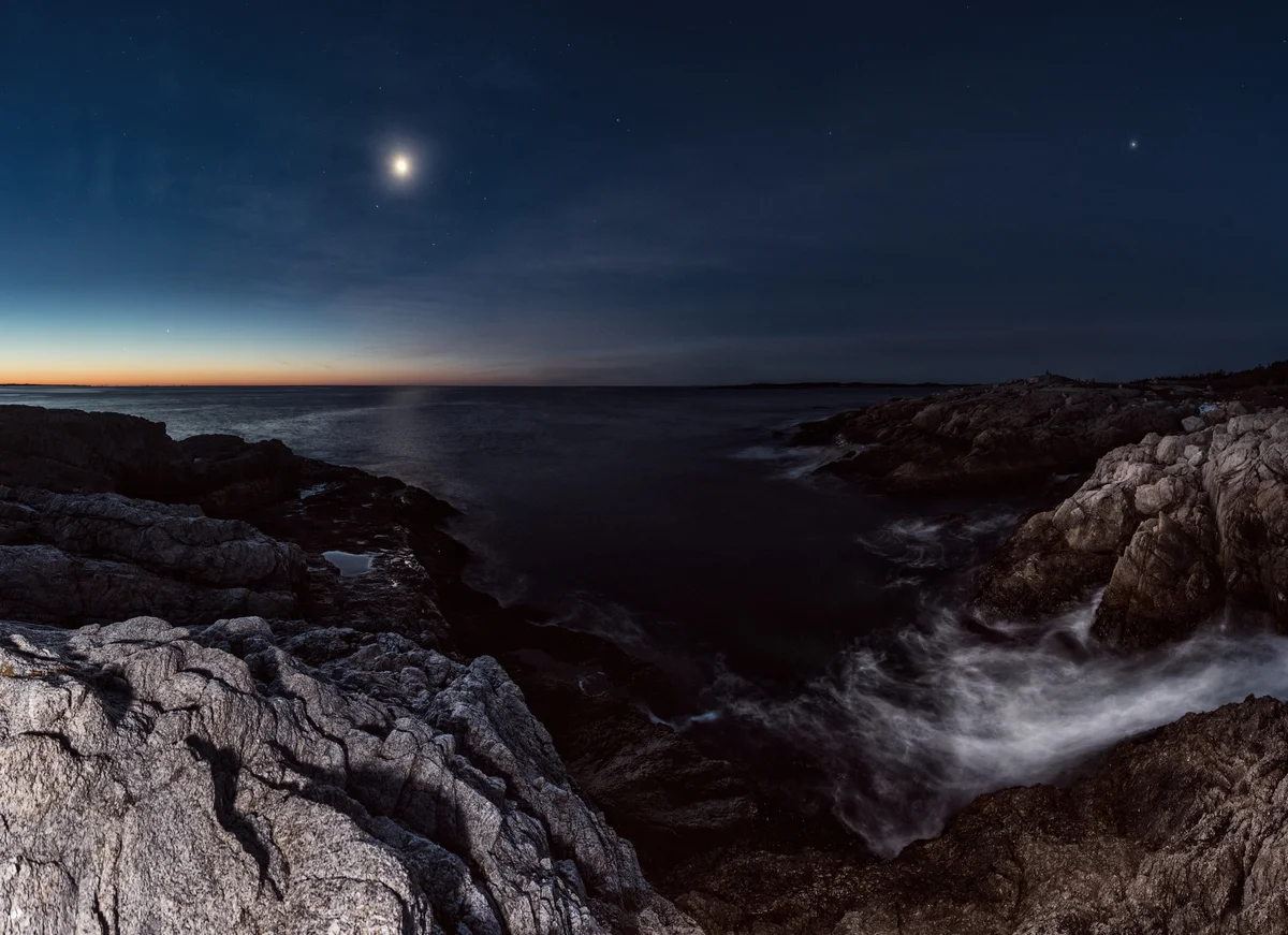Planets over a ocean landscape