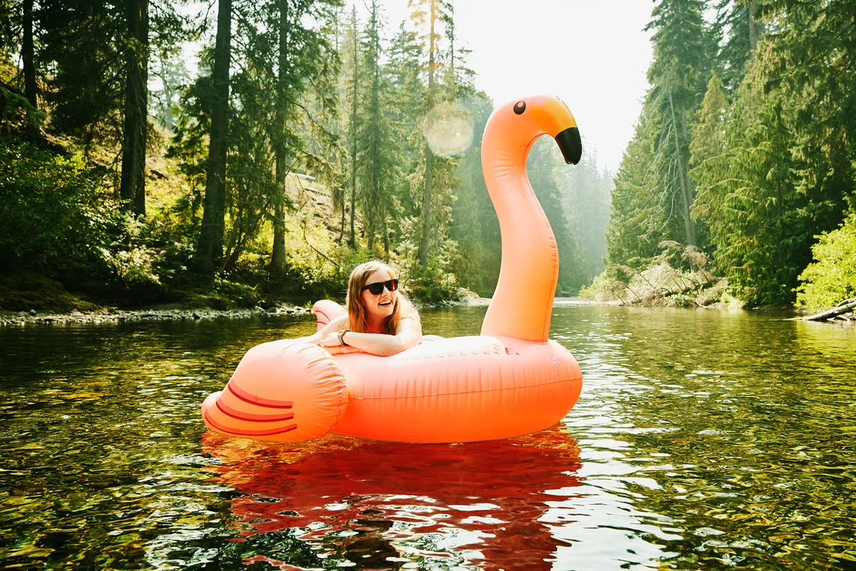 Laughing woman floating down river