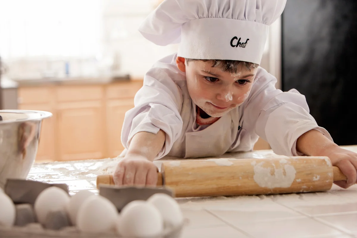 Boy rolling out dough