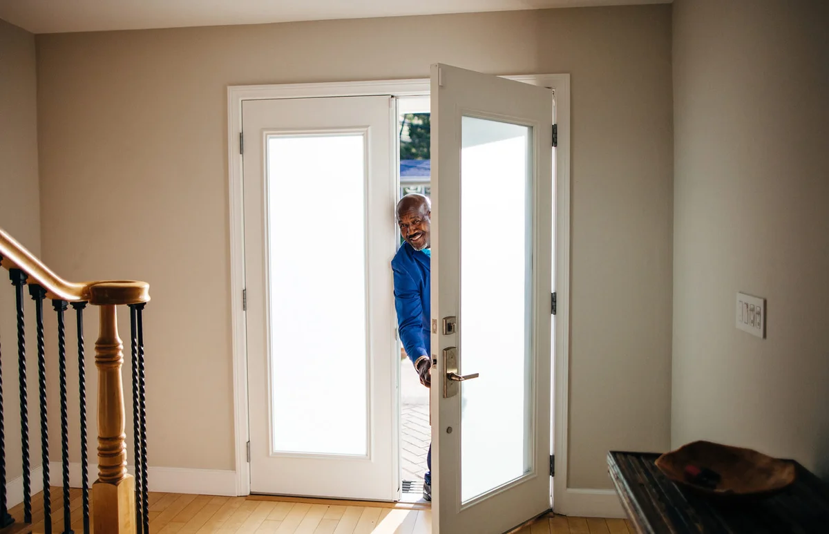 Mature man at front door of his house