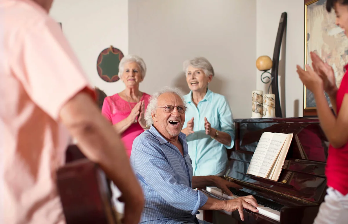 Elderly people making music in retirement home