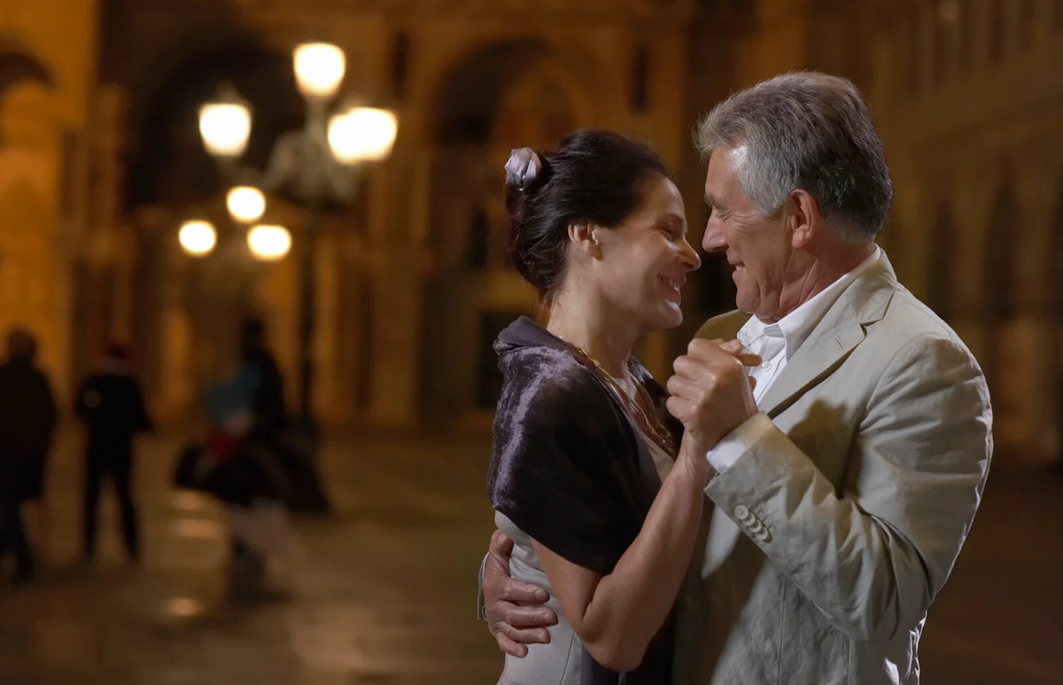 couple dancing in street at night