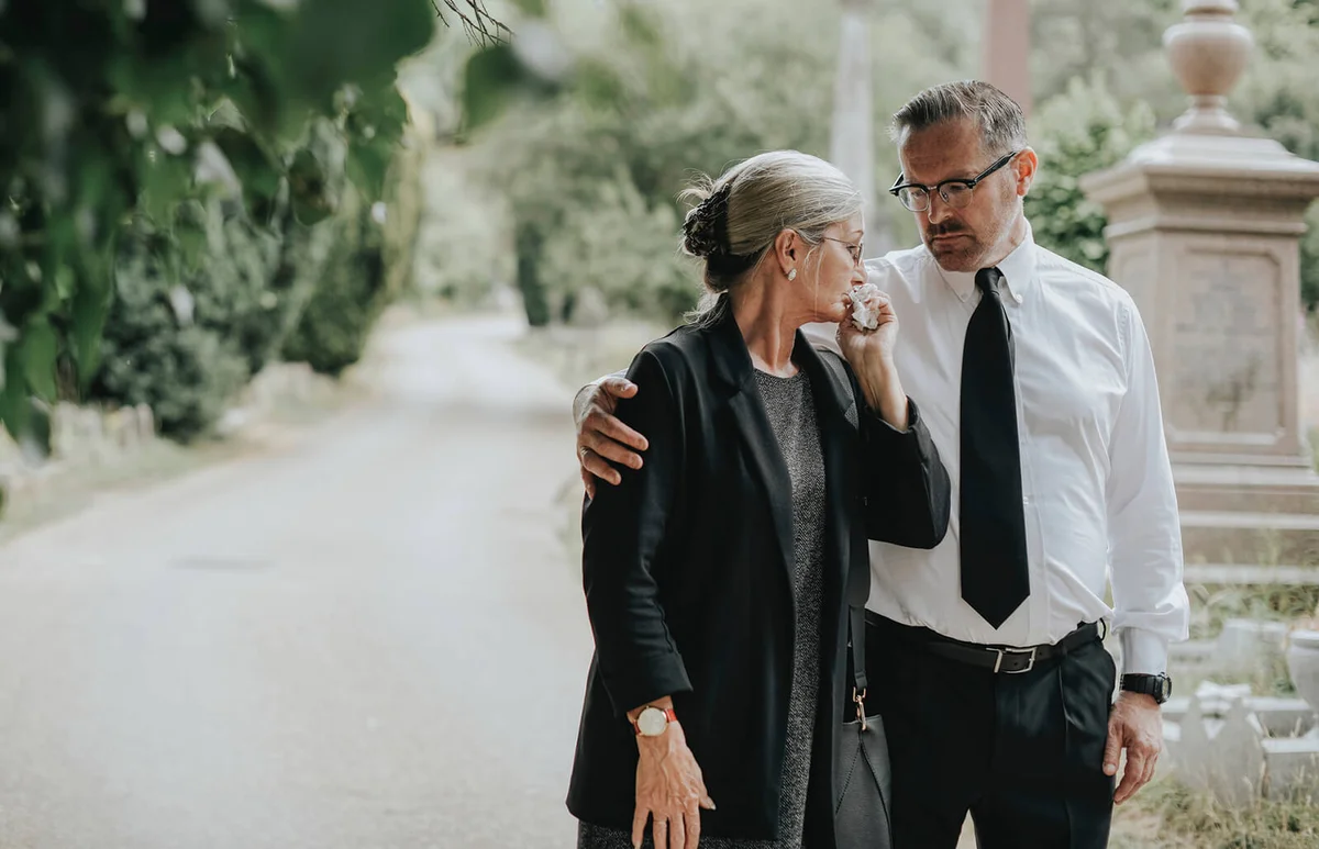 Husband trying to comfort his wife due to her loss